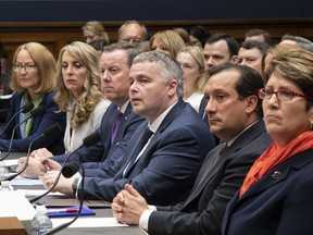 Witnesses prepare to testify before the House Commerce Oversight and Investigations Subcommittee about the Olympic community's ability to protect athletes from sexual abuse, on Capitol Hill in Washington, Wednesday, May 23, 2018. From left are: U.S. Olympic Committee Acting CEO Susanne Lyons, USA Gymnastics President and CEO Kerry Perry, USA Swimming President and CEO Tim Hinchey, USA Taekwondo CEO Steve McNally, USA Volleyball CEO Jamie Davis, and U.S. Center for SafeSport President and CEO Shellie Pfohl.