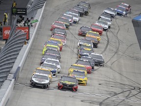 Kevin Harvick, left front, and Martin Truex Jr., right front, lead the pack as they take the green flag for the start of the NASCAR Cup Series auto race, Sunday, May 6, 2018, at Dover International Speedway in Dover, Del.