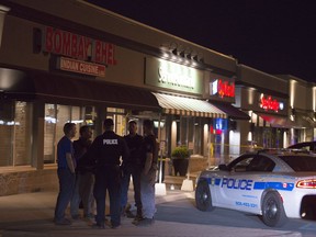 Police stand outside the Bombay Bhel restaurant in Mississauga, Ont. on Friday May 25, 2018.