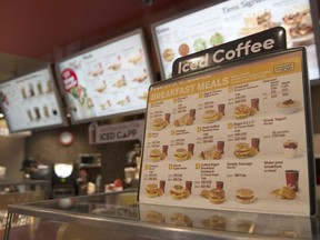 A breakfast menu, breakfast not being served at the time this image was taken, is displayed at a Tim Hortons restaurant in Toronto on Tuesday May 29, 2018. Tim Hortons will pilot all-day breakfast in a dozen Ontario locations and look to introduce a kids menu, delivery and loyalty program, in a bid to regain the trust of franchisees and customers.