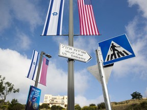 A road sign leading to the U.S. Embassy is seen ahead the official opening in Jerusalem, Sunday, May 13, 2018.