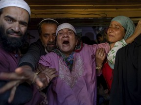 Grandmother, center, of Haseeb Ahmad Khan, one among three civilians killed, wails during the funeral of her grandson in Baramulla, 60 kilometers (37 miles) west of Srinagar, Indian controlled Kashmir, Tuesday, May 1, 2018. Suspected militants shot and killed three men in Indian-controlled Kashmir, police said on Tuesday.