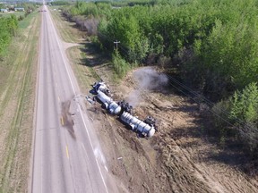 A crashed semi is shown in a handout photo from the Boyle RCMP. A highway detour is in place and homes have been evacuated due to a crash involing a semi hauling hydrochloric acid northeast of Edmonton. THE CANADIAN PRESS/HO-Boyle RCMP MANDATORY CREDIT