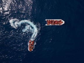 Refugees and migrants are rescued by members of the Spanish NGO Proactiva Open Arms, after leaving Libya trying to reach European soil aboard an overcrowded rubber boat, north of Libyan coast, Sunday, May 6, 2018.  In total 105 refugees and migrants from various countries, including Bangladesh, Egypt, Nigeria, Marrocos, Gana, Pakistan, Sudan, Libya, Eritrea and Senegal, were rescued in the overcrowded rubber boat.