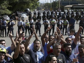 Striking truckers and motorcycle messengers block the entrance of BR Distribuidora, a fuel station run by the state-run oil company Petrobras, as they stop trucks from leaving and distributing fuel to gas stations in Brasilia, Thursday, May 24, 2018. The truckers' strike is snarling traffic and causing fuel shortages across the country as oil prices rise and Brazil's real falls against the dollar.