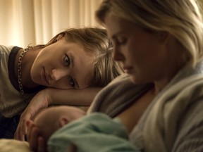 Mackenzie Davis , left, and Charlize Theron.