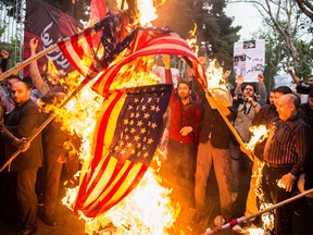 Iranians burn American flags during a demonstration outside the former U.S. embassy in Tehran on May 9, 2018.