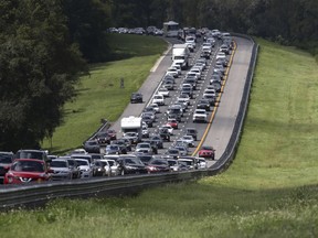 FILE- This Sept. 9, 2017 file photos, shows a long line of cars heading north from Florida on I-75, near Brooksville, Fla., in advance of Hurricane Irma.  Florida's governor and Legislature promised a dizzying array of fixes following the devastation of last year's hurricanes. But heading into Friday, June 1, 2018,  start of a new storm season, the state has enacted only a few changes.