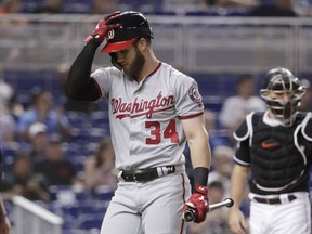 Washington Nationals' Bryce Harper (34) walks to the dugout after striking out during the first inning of a baseball game against the Miami Marlins, Friday, May 25, 2018, in Miami.