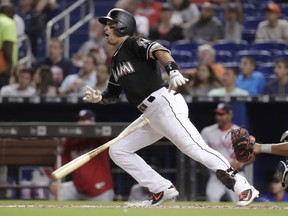 Miami Marlins' Martin Prado hits a double during the third inning of a baseball game against the Washington Nationals, Friday, May 25, 2018, in Miami.