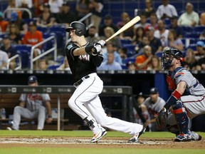 Miami Marlins' Brian Anderson watches his RBI double during the first inning of a baseball game against the Atlanta Braves, Saturday, May 12, 2018, in Miami.