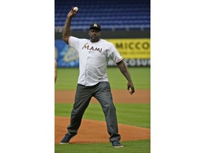 Former NBA player Shaquille O'Neal throws out a ceremonial first pitch before a baseball game between the Miami Marlins and the Atlanta Braves, Friday, May 11, 2018, in Miami.