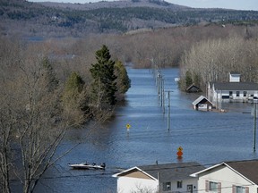 A Canadian Cost Guard craft heads across a flooded area at Darlings Island, N.B. on Saturday, May 5, 2018. Swollen rivers across New Brunswick are still rising, flooding streets and properties and forcing people from their homes in several communities.