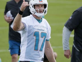 Miami Dolphins quarterback Ryan Tannehill gestures during an NFL organized team activities football practice, Wednesday, May 23, 2018, at the Dolphins training facility in Davie, Fla. Tannehill returns to the Dolphins' practice field this week for OTAs optimistic he can stay healthy after suffering a serious knee injury each of the past two years.