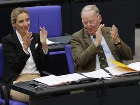 FILE - In this Oct. 24, 2017 file photo Alice Weidel, left, and Alexander Gauland, parliamentary faction leaders of the Alternative for Germany, AfD, applaud during the first meeting of the German parliament after the election in Berlin, Germany. The party that swept into Parliament last year on a wave of anti-migrant sentiment is staging a march Sunday through the heart of Berlin to protest against the government.