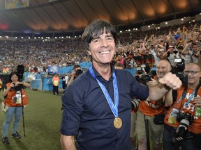 FILE - In this July 13, 2014 file photo Germany's head coach Joachim Loew celebrates after the World Cup final soccer match between Germany and Argentina at the Maracana Stadium in Rio de Janeiro, Brazil. Germany coach Joachim Loew is brimming with confidence just over three weeks before what he calls the country's "golden generation" begins its World Cup defense against Mexico.