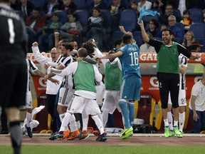 Juventus goalkeeper Gianluigi Buffon, right, celebrates with teammates at the end of the Serie A soccer match between Roma and Juventus, at the Rome Olympic stadium, Sunday, May 13, 2018. The match ended in a scoreless draw and Juventus won record-extending seventh straight Serie A title.
