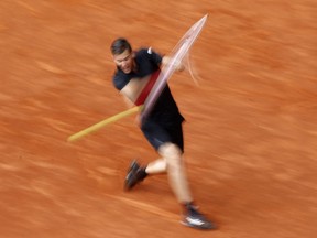 In this photo taken with a slow shutter speed photo, Austria's Dominic Thiem hits a backhand return from  South Africa's Kevin Anderson during a Madrid Open tennis tournament semi final match in Madrid, Spain, Saturday, May 12, 2018. Thiem won 6-4 and 6-2.