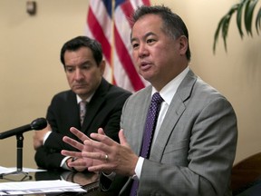 FILE - In this June 13, 2017 file photo, Assemblyman Phil Ting, D-San Francisco, right, discusses the state budget next to Assembly Speaker Anthony Rendon, D-Paramount, in Sacramento, Calif. California lawmakers are taking steps to let school employees ask judges to temporarily strip gun rights from potentially dangerous people.