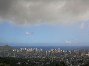 File - In this Aug. 7, 2014, file photo, clouds hang over Honolulu as Hurricane Iselle approaches. On Wednesday, May 23, 2018, NOAA's Central Pacific Hurricane Center announces the hurricane season outlook for 2018.