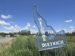 FILE - In this Thursday, May 26, 2016, file photo, a sign welcomes residents and visitors to the tiny town in Dietrich, Idaho. Residents of tge Idaho town have been told not to drink the water after a fired municipal worker was found dead in his home by emergency workers who were hospitalized after entering the residence. Dietrich Mayor Don Heiken said Friday, May 25, 2018, that 62-year-old Tom Young was found dead Thursday and that he had been fired on May 9 following an altercation that involved the police, but declined to offer details.