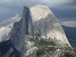 FILE - This August 2011 file photo shows Half Dome and Yosemite Valley in a view from Glacier Point at Yosemite National Park, Calif. A hiker in Yosemite National Park fell to his death while climbing the iconic granite cliffs of Half Dome in rainy conditions. The National Park Service said the accident occurred Monday, May 21, 2018. NPS spokeswoman Jamie Richards said the man and a companion were scaling the steepest part of the trail where rangers recently installed cables to help hikers get to the top of the 8,800-foot rock face.