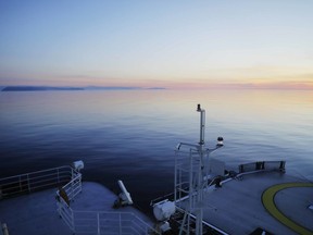 File - In this July 14, 2017 file photo, The Finnish icebreaker MSV Nordica sails past the American island of Little Diomede, Alaska, left, and behind it, the Russian island of Big Diomede, separated by the International Date Line on the Bering Strait. The International Maritime Organization has approved two-way shipping routes into the Arctic Ocean through the Bering Strait. The IMO accepted routes proposed by the United States and Russia for safe navigation between Alaska and Russia's Chukotskiy Peninsula. The routes create lanes for northbound and southbound traffic and take effect Dec. 1, 2018.