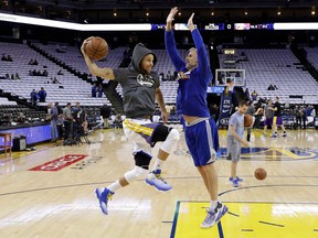 FILE - In this April 12, 2017, file photo, Golden State Warriors assistant coach Bruce Fraser, right, works with guard Stephen Curry during warmups before the team's NBA basketball game against the Los Angeles Lakers in Oakland, Calif. They call it "The Menu." There's no actual list or book. Curry and his right-hand shooting man, Fraser, keep all the details in their heads for what the two-time MVP might need to work on any given day. Maybe it's catch and shoots. Or off-the-dribble work. Sometimes, ballhandling into shot. Perhaps looking at balance, rhythm and core, or just focusing on spot shooting from various places.