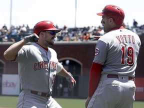 Cincinnati Reds' Adam Duvall, left, is congratulated by Joey Votto after hitting a three-run home run that scored Votto and Scooter Gennett against the San Francisco Giants during the first inning of a baseball game in San Francisco, Wednesday, May 16, 2018.