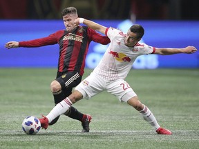 Atlanta United defender Greg Garza, left,  defends against New York Red Bulls midfielder Florian Valot, right, during the first half in a MLS soccer match Sunday, May 20, 2018, in Atlanta.