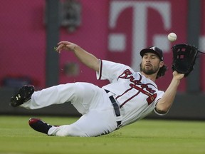 Atlanta Braves left fielder Charlie Culberson makes a sliding catch for the out on a short fly ball by New York Mets' Jose Reyes during the second inning of a baseball game Tuesday, May 29, 2018, in Atlanta.