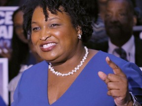 In this March 6, 2018 photo, Stacey Abrams holds a news conference to announce she has qualified to run for governor in Atlanta.   Abrams and Stacey Evans are vying for the Democratic nomination for Georgia governor.