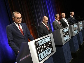 From left to right, Georgia Republican gubernatorial candidates Casey Cagle, Hunter Hill, Brian Kemp, Clay Tippins and Michael Williams wait to debate Thursday, May 17, 2018, in Atlanta.