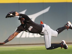 Miami Marlins left fielder Cameron Maybin (1) makes a diving catch for the out on Atlanta Braves' Ozzie Albies duirng the first inning of a baseball game Saturday, May 19, 2018, in Atlanta.