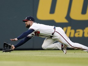 Atlanta Braves center fielder Ender Inciarte dives for a ball hit for a single by Washington Nationals' Juan Soto during the second inning of a baseball game Thursday, May 31, 2018, in Atlanta.