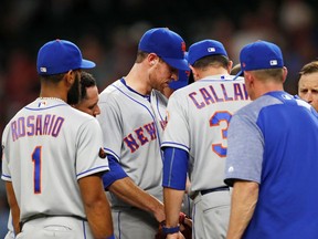 New York Mets starting pitcher Steven Matz, middle talks with manager Mickey Callaway (36) before leaving in the fourth inning of the team's baseball game against the Atlanta Braves on Tuesday, May 29, 2018, in Atlanta. Atlanta won 7-6.