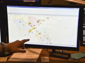 In this photo taken March 15, 2018, a supervisor shows one of the maps used by dispatchers at a 911 call center in Roswell, Ga. The Roswell call center is one of the few in the United States that accepts text messages. This year is the 50th anniversary of the first 911 call placed in the United States and authorities say it is in desperate need to have its technology modernized.