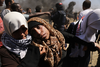 A wounded Palestinian women is carried from the border fence with Israel as mass demonstrations  continue on May 14, 2018 in Gaza.