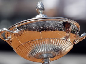 Ukraine's Elina Svitolina is reflected on the trophy during the awarding ceremony at the end of her final match against Simona Halep at the Italian Open tennis tournament, in Rome, Sunday, May 20, 2018. Svitolina won 6-0, 6-4.