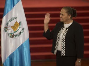 Maria Consuelo Porras Argueta raises her hand to be sworn-in as Attorney General at the National Palace in Guatemala City, Wednesday, May 16, 2018. Porras will be responsible for a number of ongoing cases including two against President Jimmy Morales.