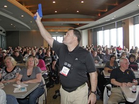 In this Thursday, Dec. 27, 2012 file photo, Clark Aposhian, president of the Utah Shooting Sport Council, holds a plastic gun during a concealed weapons training session for 200 Utah teachers in West Valley City, Utah.