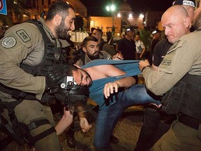 A protester is subdued in Haifa on Friday, May 18, 2018, by Israeli police during a demonstration that gave rise to allegations of police brutality.
