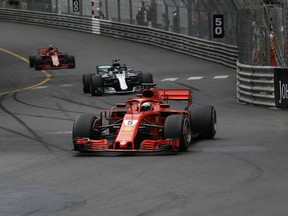 Ferrari driver Sebastian Vettel of Germany followed by Mercedes driver Lewis Hamilton of Britain and Ferrari driver Kimi Raikkonen of Finland during the Formula One race, at the Monaco racetrack, in Monaco, Sunday, May 27, 2018.