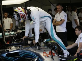 Mercedes driver Lewis Hamilton of Britain gets in his car in the team box during the third free practice at the Monaco racetrack, in Monaco, Saturday, May 26, 2018. The Formula one race will be held on Sunday.