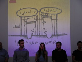 This picture taken Thursday, May 17, 2018, shows members of Lebanon's pioneering LBGT advocacy group Helem or dream speak during a press conference in Beirut, Lebanon.   Arabic on wall reads "Are you a sodomite? No I am homosexual, up,. If you want to talk to me, at least do it properly."  Lebanon's relative tolerance emerges in part from its sectarian and ethnic diversity. Despite tensions, no one group is strong enough to impose its will, and people are forced to recognize others to a degree. That has opened up a greater freedom of press, expression and activism than elsewhere in the region.