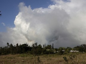 Gases rise from lava fissure 17 after it erupted early Sunday, May 13 2018 near Pahoa, Hawaii.The new fissure emitting steam and lava spatter spurred Hawaii officials to call for more evacuations on Sunday as residents braced for an expected eruption from the Kilauea volcano.