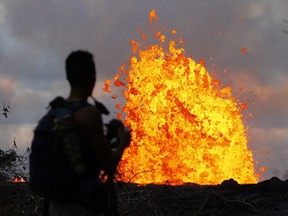 In this May 23, 2018 photo, lava erupts in the air in Leilani Estates area near Pahoa, Hawaii. The Kilauea volcano has opened more than 20 vents in the ground that have released lava, sulfur dioxide and steam.