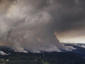 A plume of volcanic steam rises from the alignment of fissures in Hawaii's Kilauea East Rift zone, Wednesday, May 16, 2018. Earthquakes were damaging roads and buildings on Hawaii's Big Island on Wednesday as ash emissions streamed from Kilauea volcano.