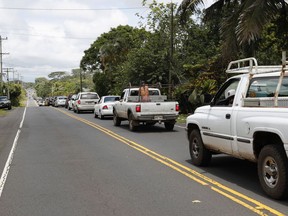 A line of traffic is seen going towards Pahoa town, Sunday, May 6, 2018, near Pahoa, Hawaii. Scientists reported lava spewing more than 200 feet (61 meters) into the air in Hawaii's recent Kilauea volcanic eruption, and some of the more than 1,700 people who evacuated prepared for the possibility they may not return for quite some time.