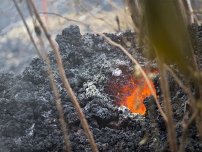 Lava glows from a vent on a lava bed at the Leilani Estates, Saturday, May 5, 2018, in Pahoa, Hawaii. The Hawaiian Volcanoes Observatory said eight volcanic vents opened in the Big Island residential neighborhood of Leilani Estates since Thursday.